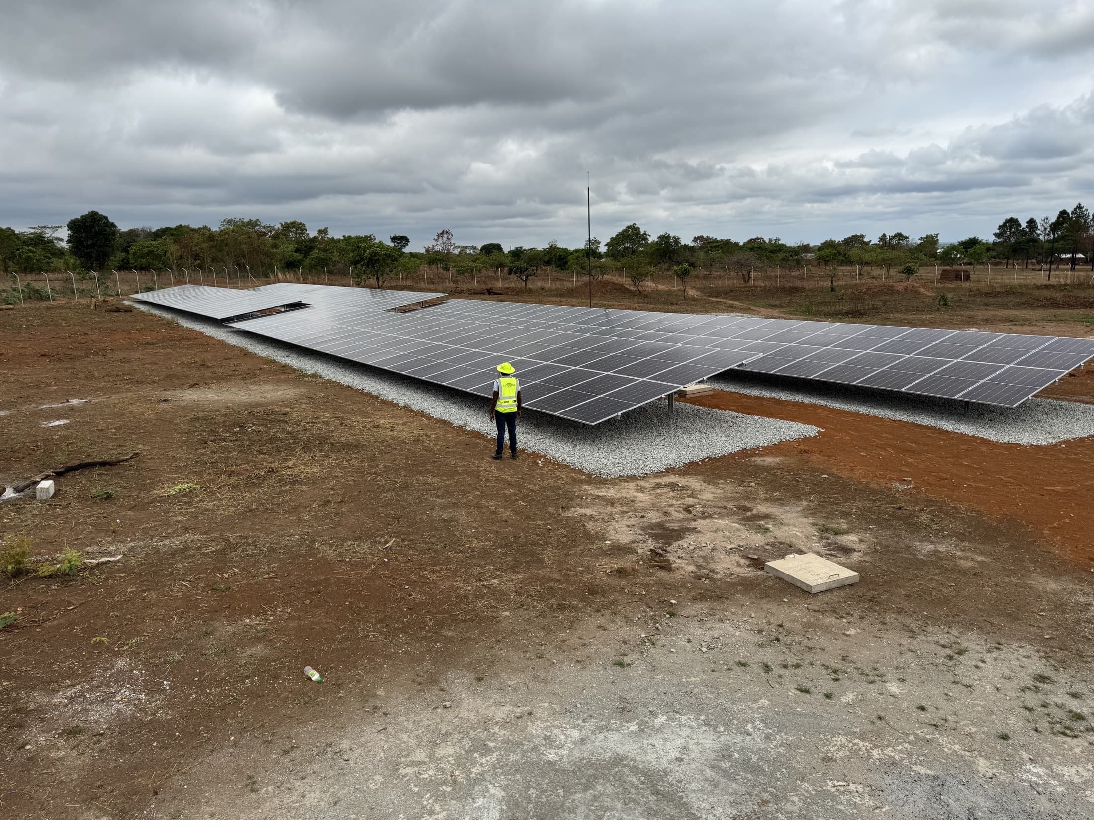 Solarmai project archive showing a ground-mounted solar installation and field engineer